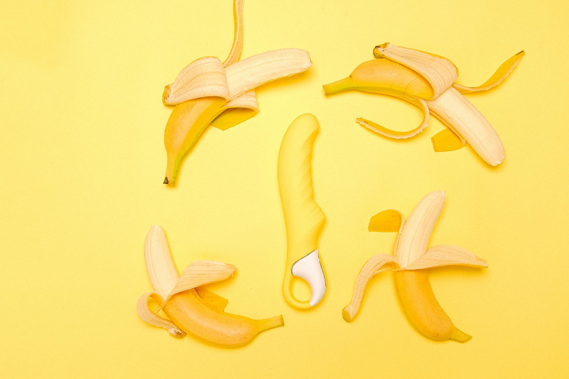 Yellow silicone lemon vibrator on a bright background